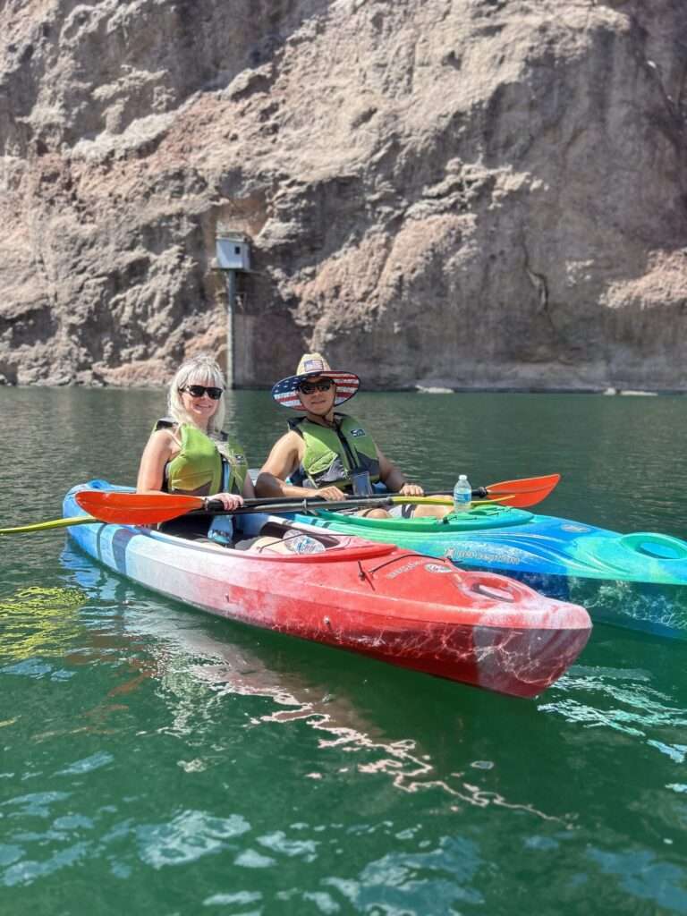 Two Kayakers Wearing Shades Smile While On Colorado River Las Vegas Kayak Tour scaled 1 Veteran Kayaks