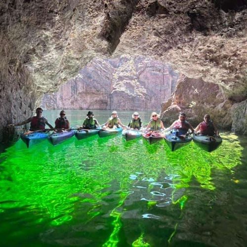 Eight Kayakers posing on their Emerald Cave Kayak Tour with Veteran Kayaks near las vegas.