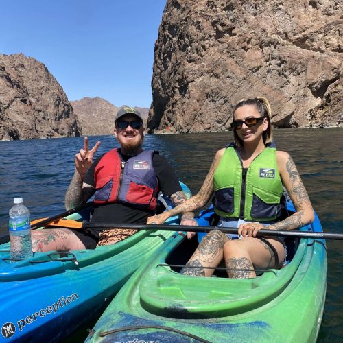 Two-Kayakers-On-The-Colorado-River-One-Is-Showing-Peace-Sign-Las-Vegas-Kayak-Tour-scaled.jpg