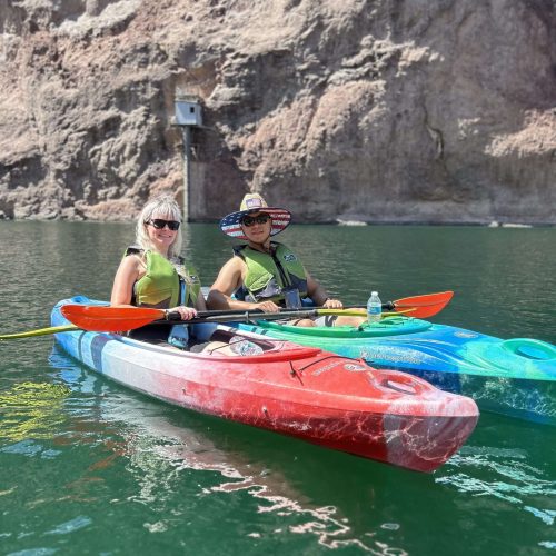 Two-Kayakers-Wearing-Shades-Smile-While-On-Colorado-River-Las-Vegas-Kayak-Tour-scaled.jpg