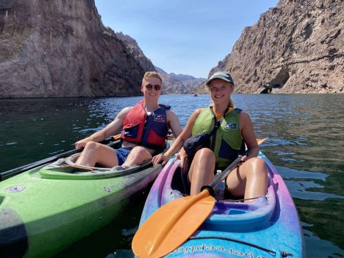 Two-Women-Kayaking-Colorado-River-Smiling-Las-Vegas-Kayak-Tour-scaled.jpg